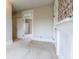 Bedroom with white trim and fireplace, featuring two doors and neutral carpet at 5752 River Rd, Waldron, IN 46182