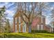 Charming two-story brick home with mature trees and a well-manicured lawn on a partly cloudy day at 5752 River Rd, Waldron, IN 46182