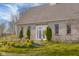 Stone home featuring a well-manicured lawn and beautiful trees around the property at 5752 River Rd, Waldron, IN 46182