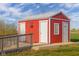 Exterior of the red barn with multiple doors and ramp at 5752 River Rd, Waldron, IN 46182