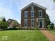 Classic brick home with a manicured lawn, charming details, and secondary building at 5752 River Rd, Waldron, IN 46182