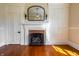 Charming fireplace nestled between built-in storage cabinets, complemented by hardwood floors and natural light at 5752 River Rd, Waldron, IN 46182
