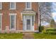 Inviting front entry of a brick home featuring a decorative portico, sidelights, and brick pathway at 5752 River Rd, Waldron, IN 46182