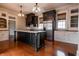 Modern kitchen with dark cabinetry, marble countertops, stainless steel appliances, and pendant lighting at 5752 River Rd, Waldron, IN 46182