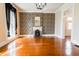 Spacious living room with a decorative fireplace and hardwood floors, illuminated by natural light at 5752 River Rd, Waldron, IN 46182
