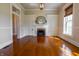 Elegant living room showcasing hardwood floors and a cozy fireplace with built-in storage at 5752 River Rd, Waldron, IN 46182