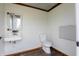 Clean restroom with modern toilet, sink, and baby changing station for public convenience at 5752 River Rd, Waldron, IN 46182