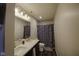 Bathroom featuring double sinks, modern fixtures, and decorative shower curtain at 5810 Grand Ave, Plainfield, IN 46168