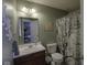 Cozy bathroom showcasing a decorative shower curtain, vanity, and ample lighting at 5810 Grand Ave, Plainfield, IN 46168