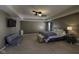 Large primary bedroom with seating area, tray ceiling, and modern ceiling fans at 5810 Grand Ave, Plainfield, IN 46168
