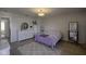 Neutral bedroom with mirror, rug, bed, and white accent furniture at 5810 Grand Ave, Plainfield, IN 46168