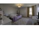 Neutral bedroom with bright window, bed, floor mirror and white accent furniture at 5810 Grand Ave, Plainfield, IN 46168