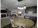 Open-concept dining area features a rustic table, stylish lighting, and views of the living space at 5810 Grand Ave, Plainfield, IN 46168