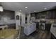 Modern kitchen features stainless steel appliances, gray cabinetry, and granite countertops at 5810 Grand Ave, Plainfield, IN 46168