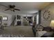 An open-concept living room features a ceiling fan, neutral palette, and seamless kitchen access at 5810 Grand Ave, Plainfield, IN 46168