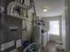 Utility Room contains a modern furnace, water heater, shelving and a washer/dryer at 5810 Grand Ave, Plainfield, IN 46168