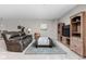 Finished basement area with comfortable seating, rug, side table, and decor at 6504 W May Apple Dr, McCordsville, IN 46055