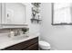Cozy bathroom with dark wood vanity, neutral countertop and simple design at 6504 W May Apple Dr, McCordsville, IN 46055