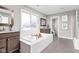 Bright bathroom featuring a soaking tub, double vanity, and modern finishes and a shower at 6504 W May Apple Dr, McCordsville, IN 46055