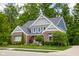 Charming two-story brick home with lush landscaping and inviting front porch at 6504 W May Apple Dr, McCordsville, IN 46055