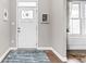 Bright foyer with stylish rug, door, and natural light at 6504 W May Apple Dr, McCordsville, IN 46055