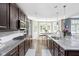 Bright, open kitchen with stainless steel appliances, granite countertops, and a view to the breakfast area at 6504 W May Apple Dr, McCordsville, IN 46055