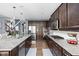 Modern kitchen featuring granite counters, stainless appliances, dark cabinetry, and an open layout at 6504 W May Apple Dr, McCordsville, IN 46055