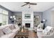 Inviting living room with a fireplace, built-in bookcases, hardwood floors, and stylish, comfortable seating at 6504 W May Apple Dr, McCordsville, IN 46055