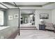 Spacious main bedroom with a four-poster bed, tray ceiling, and connecting sitting area at 6504 W May Apple Dr, McCordsville, IN 46055