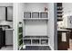 Well-organized mudroom with storage cubbies, hooks, and a convenient bench, leading to the kitchen at 6504 W May Apple Dr, McCordsville, IN 46055