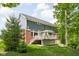 Back exterior featuring a deck, well-maintained lawn, and brick/siding combination at 6504 W May Apple Dr, McCordsville, IN 46055