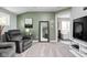 Comfortable sitting area with a recliner and a view into a Primary bath with a large tub at 6504 W May Apple Dr, McCordsville, IN 46055
