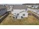 Backyard aerial shows patio, grill, seating area, and grass yard at 6705 Park Grove Blvd, Whitestown, IN 46075