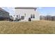 Large backyard with cozy patio featuring grill, outdoor seating, and sliding door access at 6705 Park Grove Blvd, Whitestown, IN 46075