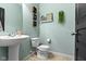 Charming half bathroom featuring a pedestal sink, a toilet, and tasteful decorations at 6705 Park Grove Blvd, Whitestown, IN 46075