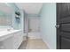 Bathroom featuring blue walls, a vanity with storage space, tiled floors, and a shower-tub combo at 6705 Park Grove Blvd, Whitestown, IN 46075