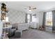 Charming Bedroom with a gray accent wall, a crib, a chair with ottoman, and cheerful decor at 6705 Park Grove Blvd, Whitestown, IN 46075