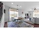 Bright dining area featuring a wood table, seating for four, an elegant light fixture, and an adjacent living area at 6705 Park Grove Blvd, Whitestown, IN 46075