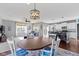 Open-concept dining area with a wood table, an adjacent kitchen, and access to a bright and airy living room at 6705 Park Grove Blvd, Whitestown, IN 46075