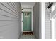 Close up of front door with glass panes, a welcome mat, and an exterior light at 6705 Park Grove Blvd, Whitestown, IN 46075