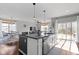 Open-concept kitchen island with stainless steel dishwasher flows into the dining and living areas at 6705 Park Grove Blvd, Whitestown, IN 46075