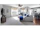 Comfortable living room with a plush sectional sofa, neutral carpeting, ample natural light, and a ceiling fan at 6705 Park Grove Blvd, Whitestown, IN 46075