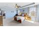 Bright and airy main bedroom with large windows, tray ceiling and a cozy seating area at 6705 Park Grove Blvd, Whitestown, IN 46075