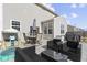 Relaxing patio with dark wicker seating, round table with umbrella, and barbecue at 6705 Park Grove Blvd, Whitestown, IN 46075