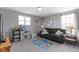 Bright playroom features a comfortable sofa, play kitchen and large windows providing ample natural light at 6705 Park Grove Blvd, Whitestown, IN 46075