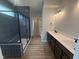 Modern bathroom featuring a walk-in shower, vanity with storage, and stylish finishes at 7227 Bailow Ct, McCordsville, IN 46055