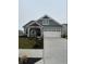 Charming single-Gathering home featuring a two-car garage, stone accents, and manicured landscaping at 7227 Bailow Ct, McCordsville, IN 46055