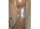 Hallway featuring patterned tile flooring and an entryway nook with storage and hooks at 7227 Bailow Ct, McCordsville, IN 46055