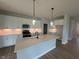 Modern kitchen boasts white cabinets, stainless steel appliances, and an island with pendant lighting at 7227 Bailow Ct, McCordsville, IN 46055