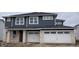 Charming two-story home boasts dark siding, white brick accents, and a two-car garage at 815 Allandale Ave, Westfield, IN 46074